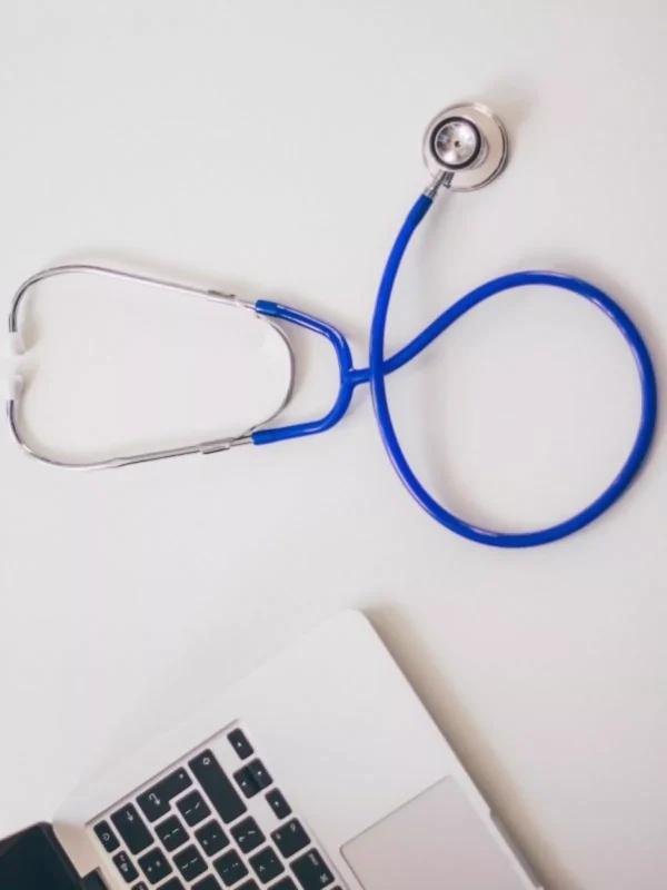 Un stéthoscope à coté d'un ordinnateur